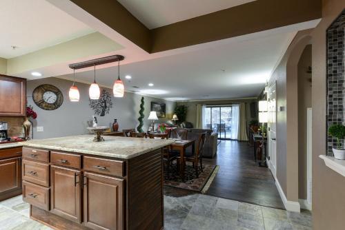 a kitchen with a large island and a dining room at Comfortable updated Condo with No steps in Branson