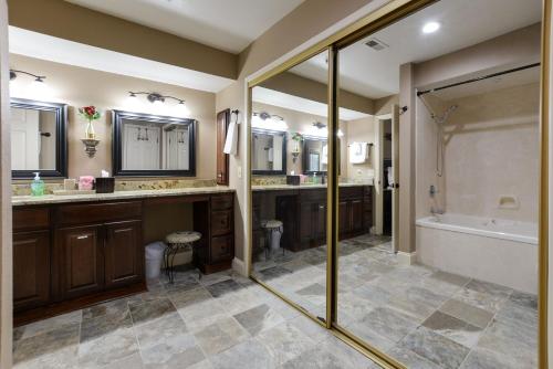 une salle de bain avec deux lavabos, une baignoire et une douche dans l'établissement Comfortable updated Condo with No steps, à Branson