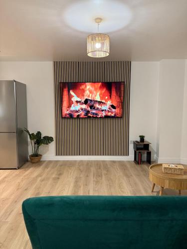 a living room with a couch and a painting on the wall at Modern Refurbished Apt in Stevenage Town Centre in Stevenage