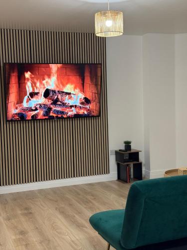 a living room with a fireplace in the wall at Modern Refurbished Apt in Stevenage Town Centre in Stevenage
