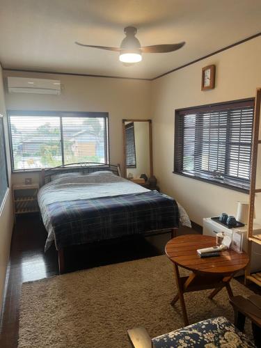 a bedroom with a bed and a table at base-k49guesthouse in Tenri