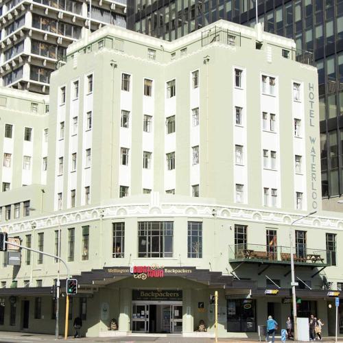 a large white building on the corner of a street at Hotel Waterloo & Backpackers in Wellington