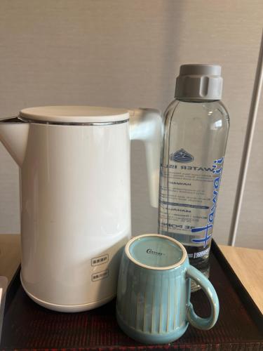 a counter with a blender and a cup and a bottle at base-k49 in Tenri