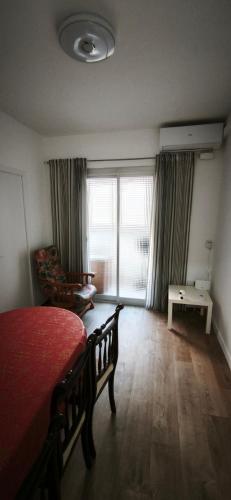 a bedroom with a bed and a desk and a window at Playa de Sant Adrià de Besòs in Sant Adria de Besos