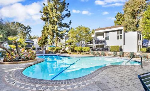 a swimming pool in front of a house at A Tranquil Retreat in Tarzana CA in Tarzana