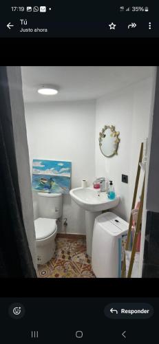 a bathroom with a toilet and a sink at Buganvilla in Tarifa