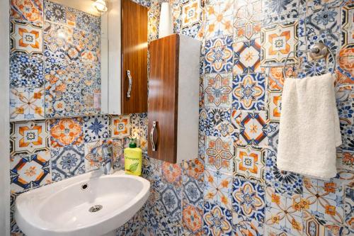 een badkamer met blauwe en witte tegelwanden en een wastafel bij Sultanahmet Center View Apart Hotel in Istanbul