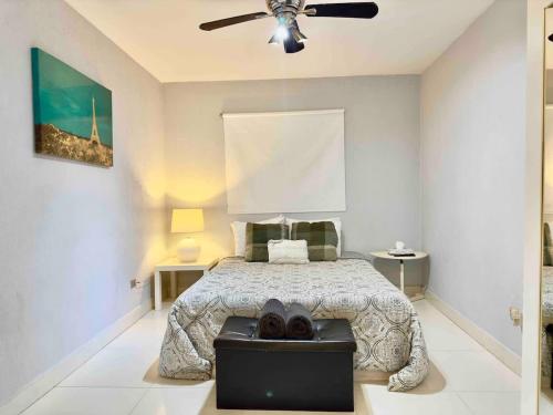 a bedroom with a bed and a ceiling fan at Oceanfront Rosarito Balcony Beach & Amazing Sunsets in Rosarito Beach