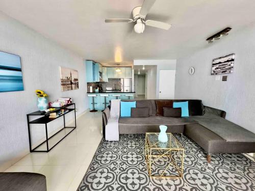 a living room with a couch and a table at Oceanfront Rosarito Balcony Beach & Amazing Sunsets in Rosarito Beach