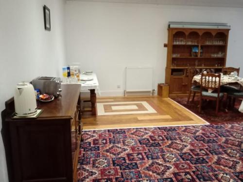 a room with a kitchen with a counter and a rug at The Limes Guesthouse Montrose in Montrose