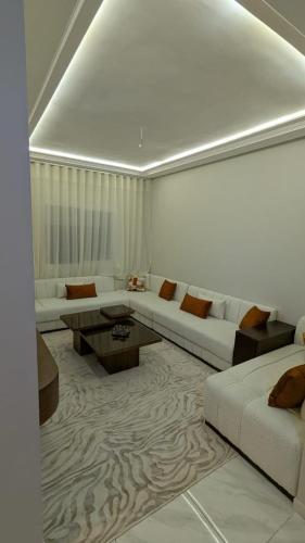 a living room with a couch and a table at NAYA apartment in Fez