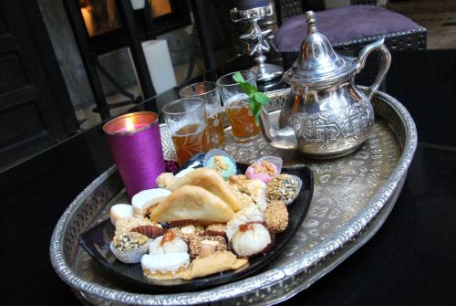 a tray with a plate of pastries on a table at Riad Terra Bahia in Marrakech