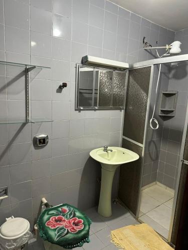 une salle de bains avec douche, lavabo et toilettes dans l'établissement Residencial Brila Mar, à Capão da Canoa