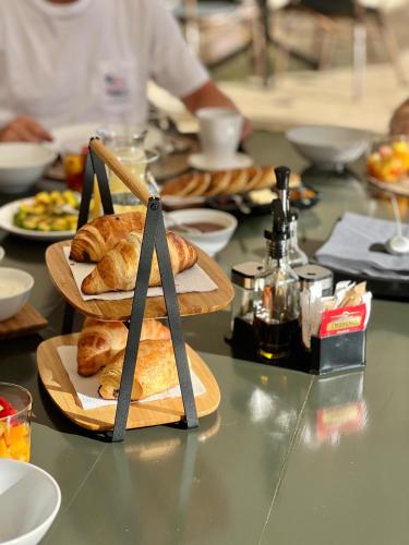 a table with plates of pastries on top at La Pala Suites in Las Terrenas