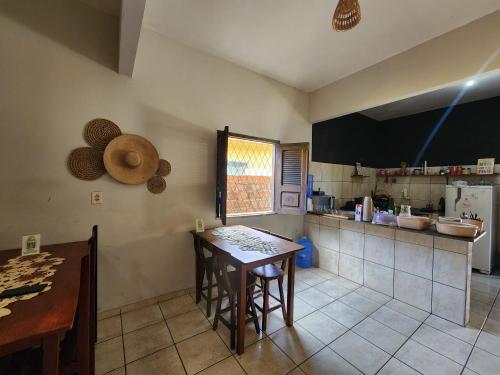 a kitchen with a table and a counter top at Mini Hostel in Tutóia