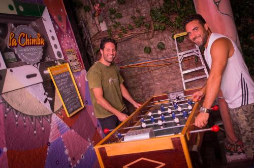 two men standing in front of a giant chessboard at La Chimba Hostel in Santiago