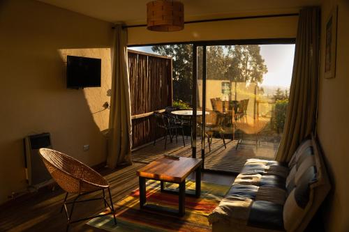 Et opholdsområde på Cabañas y Spa Costa Patagonia - Piscina Climatizada