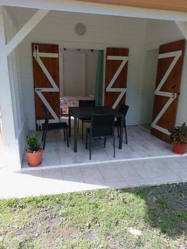 a patio with a black table and two chairs at Brada Gites2 in Deshaies