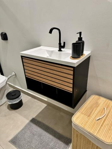a bathroom with a sink and a toilet at Refugio 890 in Tubarão