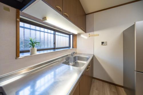 a kitchen with a sink and a window at FUJIMI Place in Yamanashi