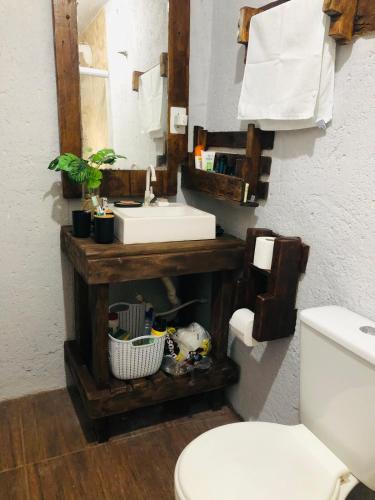 a bathroom with a sink and a mirror at Casa Praia in Palhoça