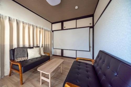 a living room with a couch and a table at FUJIMI Place in Yamanashi