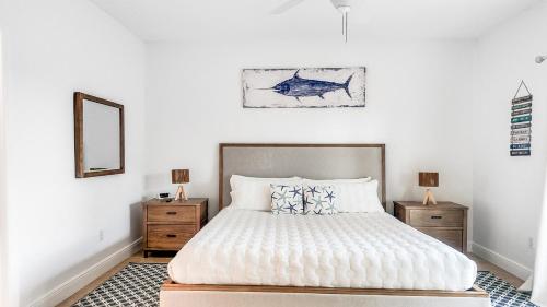 a bedroom with a bed with a fish painting on the wall at 2 BDM, 2 Bath - Bimini Bay Resort in Bailey Town