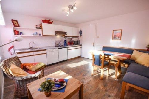 a living room with a couch and a table at Haus Seerose, Nr 8 in Baltrum