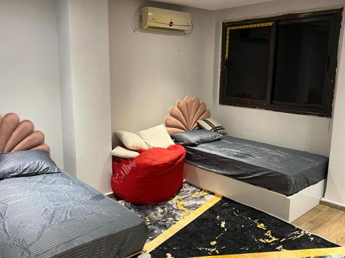 a room with two beds and a window at One Bedroom Apartment - Port Said Sea View Chalet in Port Said