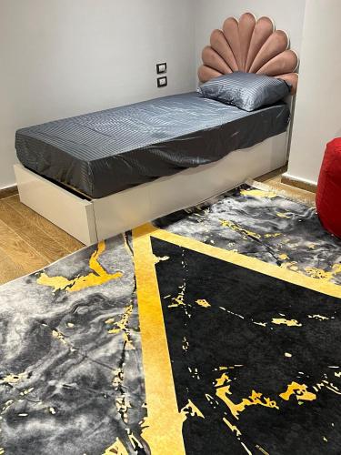 a bed in a room with a black and yellow rug at One Bedroom Apartment - Port Said Sea View Chalet in Port Said