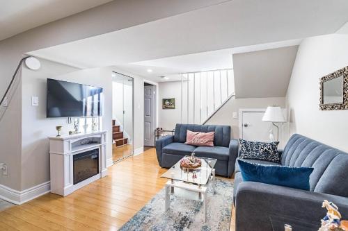 a living room with a couch and a tv at Entire Basement Apartment in Toronto