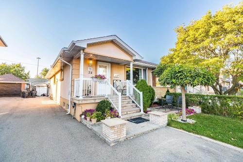 a house with a staircase in front of it at Entire Basement Apartment in Toronto