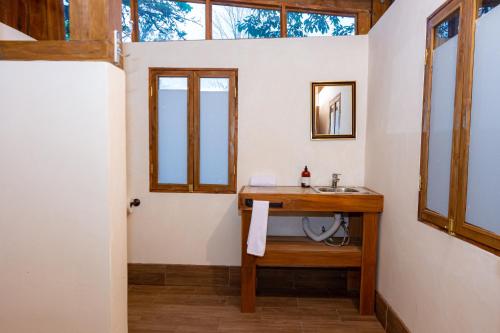a bathroom with a sink and a mirror at Bhoga Forest 