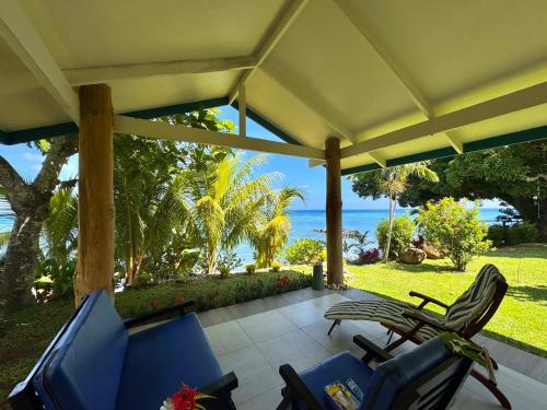 a patio with chairs and a view of the ocean at The Pointe Taveuni in Matei
