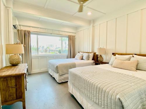 a bedroom with two beds and a window at Bayou Breeze Retreat in Orange Beach