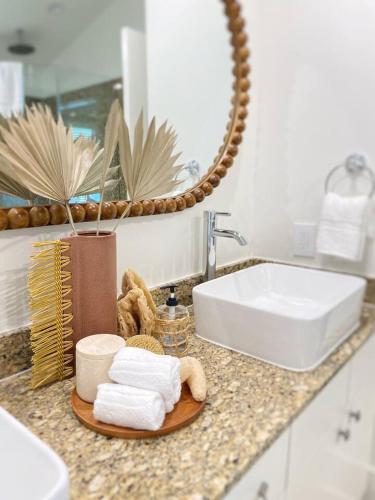 a bathroom counter with a sink and towels at Bayou Breeze Retreat in Orange Beach