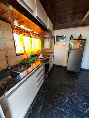 una piccola cucina con lavello e frigorifero di Casa cómoda y familiar a Necochea