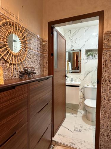 a bathroom with a sink and a toilet and a mirror at Marrakech Airport in Marrakesh