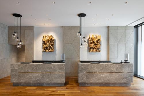 a gallery with two bronze sculptures on the wall at Miyako City Osaka Hommachi in Osaka