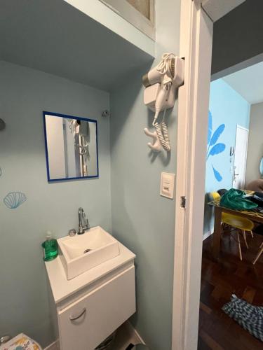 a bathroom with a sink and a toilet and a mirror at Apartamento Charme da Glória in Rio de Janeiro