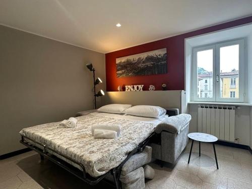 a bedroom with a bed in a room with a window at Como Lake, lakefront 30m in Como