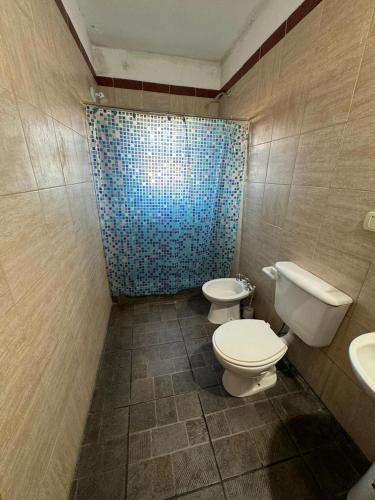 a bathroom with two toilets and a shower at Casa Punta Iglesia in Paso de la Patria