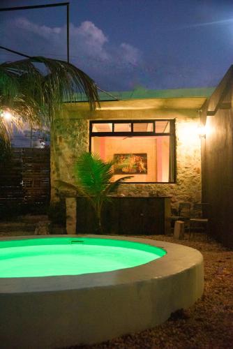 a swimming pool in front of a house at night at Habitación frente al mar y alberca in Lerma