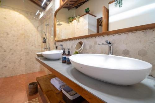 a bathroom with a large white sink and a mirror at Kibubu Forever Bali in Bedugul