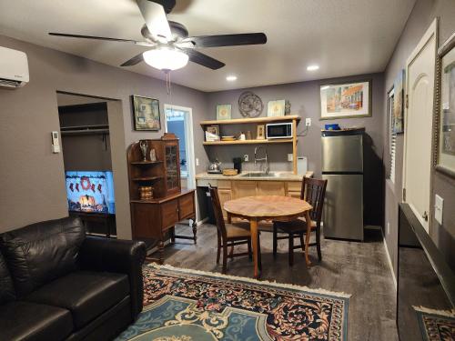 a living room with a table and a kitchen at Sunrise Springs in Pahrump