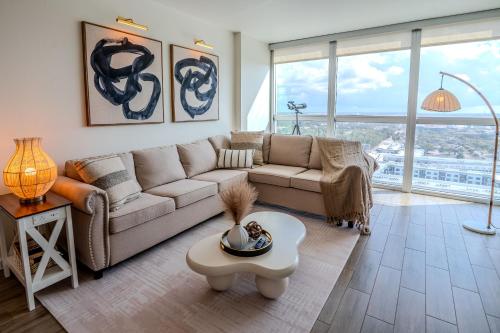 a living room with a couch and a table at Skyline Serenity City Views, Pool, Hot Tub & Gym in Fort Myers