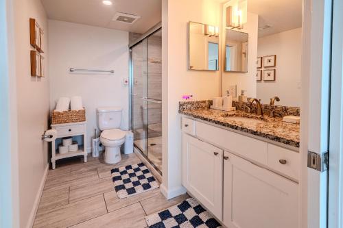a bathroom with a shower and a sink and a toilet at Skyline Serenity City Views, Pool, Hot Tub & Gym in Fort Myers