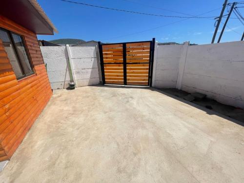 a garage with a wooden door on the side of a building at Gadir hostel in Coquimbo