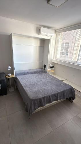 a bedroom with a large bed in a room with two windows at Espacio Centro in La Plata