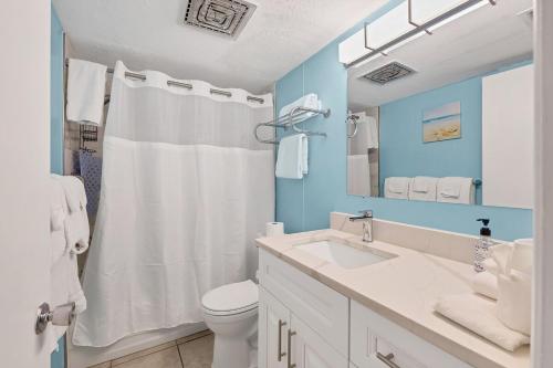 a bathroom with a white sink and a toilet at 2BR Renovated Siesta Key Condo, beach and pool access in Sarasota